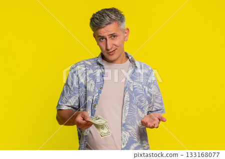Man pulling out last dollar bills from pocket and spreading hands showing broke or no money gesture Man pulling out last dollar bills from pocket and spreading hands showing broke or no money gesture 133168077