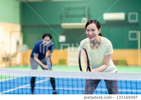 Young men and women playing tennis at a sports gym. Photo courtesy of Sports Club & Sauna Spa Renaissance Makuhari 24 133168497