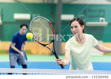 Young men and women playing tennis at a sports gym. Photo courtesy of Sports Club & Sauna Spa Renaissance Makuhari 24 133168498