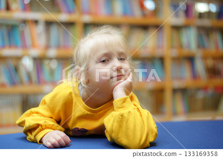 cute little girl looking at the book cute little girl looking at the book 133169358