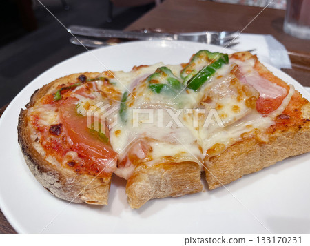 Pizza toast with melted cheese: A quick and easy breakfast or snack. Pizza toast with melted cheese: A quick and easy breakfast or snack. 133170231