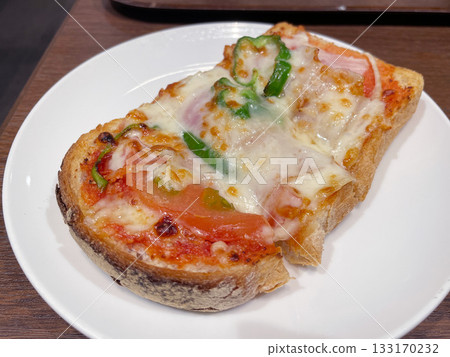 Pizza toast with melted cheese: A quick and easy breakfast or snack. Pizza toast with melted cheese: A quick and easy breakfast or snack. 133170232