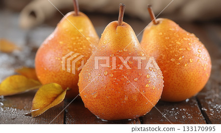 Three Fresh Pears With Dewdrops on Rustic Wooden Tabletop 133170995