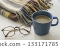 Winter coffee time with a mug, glasses and a blanket 133171785