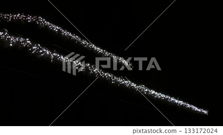 Fuzzy garland lights in the night. A view of the lights of a Christmas garland against the dark night sky of a private house. Christmas garland on the house at night 133172024