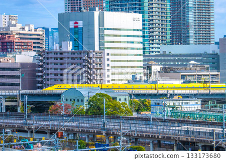 Tokyo cityscape in Japan, with views of the Shinkansen "Doctor Yellow" that brings good fortune, Kansai Electric Power Company, and high-rise apartment buildings in Shibaura 133173680