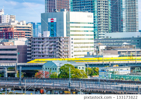 Tokyo cityscape in Japan, with views of the Shinkansen "Doctor Yellow" that brings good fortune, Kansai Electric Power Company, and high-rise apartment buildings in Shibaura Tokyo cityscape in Japan, with views of the Shinkansen "Doctor Yellow" that brings good fortune, Kansai Electric Power Company, and high-rise apartment buildings in Shibaura 133173822