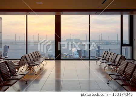Airport departure lounge at sunset, travel concept. Airport departure lounge at sunset, travel concept. 133174343