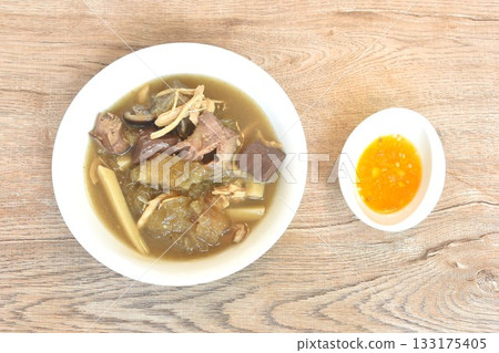 braised fish maw with bamboo shoot and pork blood with chicken organ in red gravy soup on bowl braised fish maw with bamboo shoot and pork blood with chicken organ in red gravy soup on bowl 133175405