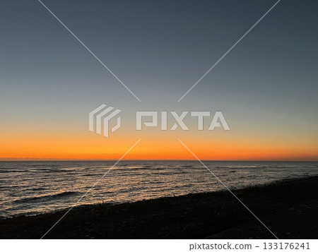 A shining sunrise over the winter sea in Japan A shining sunrise over the winter sea in Japan 133176241