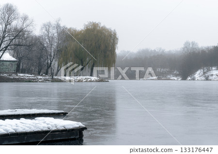 Snow-Covered Floating Docks on a Frozen Lake in Ukraine 133176447