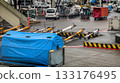 Cargo handling equipment for airplanes on wet tarmac at airport ready for use on rainy day. Industrial, operational and logistical aspects of aviation. Abstract and detailed view of airport machinery 133176495