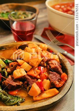Delicious homemade beef stew with vegetables served in a rustic bowl Delicious homemade beef stew with vegetables served in a rustic bowl 133176531