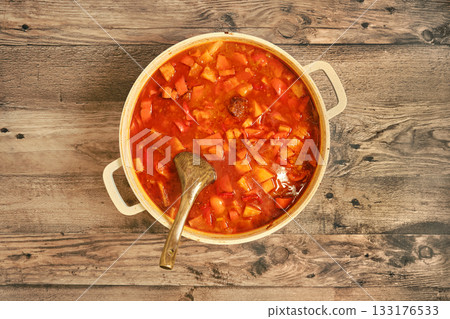 Savory beef stew simmering in a pot with vibrant vegetables and rich broth Savory beef stew simmering in a pot with vibrant vegetables and rich broth 133176533