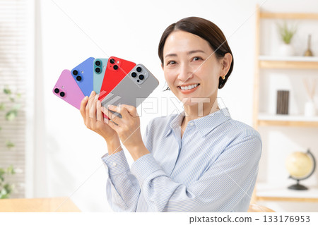Woman holding a smartphone Woman holding a smartphone 133176953