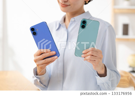 Woman holding a smartphone Woman holding a smartphone 133176956