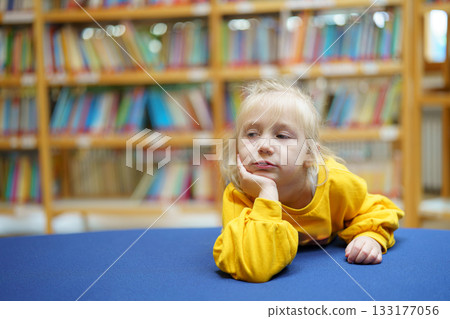 cute little girl looking at the book 133177056