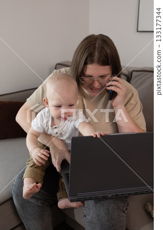 parent juggling work and childcare efficiently, parent managing work and baby simultaneously at home desk parent juggling work and childcare efficiently, parent managing work and baby simultaneously at home desk 133177344