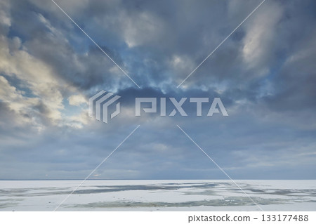 Landscape of the frozen Baltic Sea against the background of the evening sky 133177488