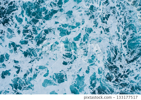 Aerial view of the waves in the Barents Sea near the shore, close-up view down Aerial view of the waves in the Barents Sea near the shore, close-up view down 133177517