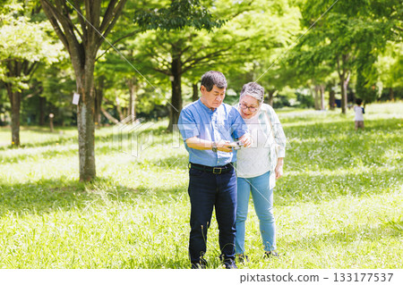Senior couple taking a walk in the fresh greenery 133177537