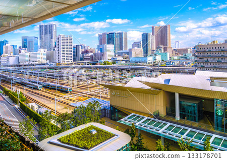 Tokyo cityscape in Japan: Shinkansen, two Keihin-Tohoku lines, tower apartment complexes such as Shibaura Island Cape Tower... 133178701