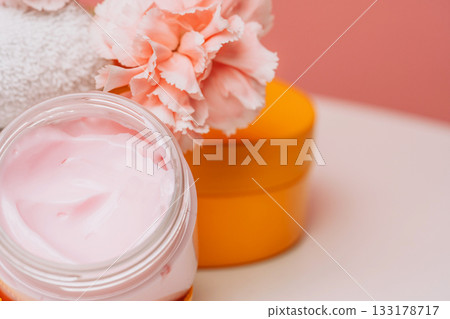 Face cream jar with carnations and yellow lid 133178717