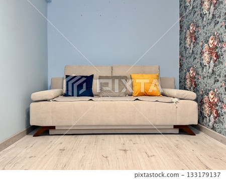 Beige sofa with colorful pillows in the apartment Beige sofa with colorful pillows in the apartment 133179137