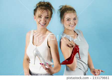 Women presenting high heels shoes Women presenting high heels shoes 133179661