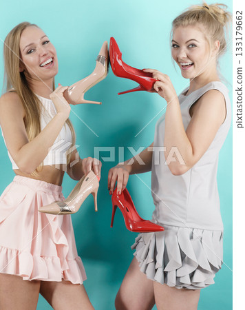 Women presenting high heels shoes Women presenting high heels shoes 133179662
