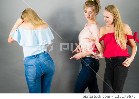 Woman being gossiped by two females Woman being gossiped by two females 133179673