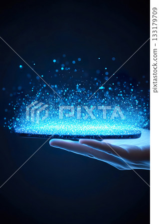 Hand Holding Tablet Displaying Glowing Particle Cloud in Dark Environment. 133179709