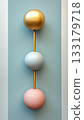 Modern decorative wall art with spherical shapes in gold, blue and pink tones. 133179718