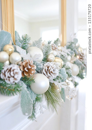 Elegant winter garland with pinecones and ornaments on fireplace mantel. Elegant winter garland with pinecones and ornaments on fireplace mantel. 133179720