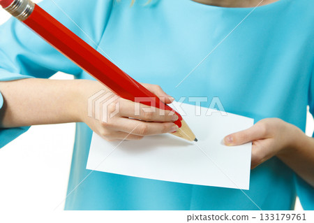 Woman with big pencil writing on paper 133179761