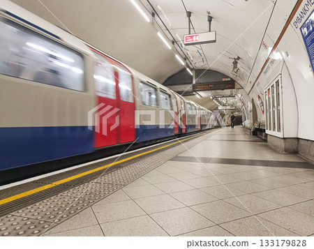 London Underground train arriving at empty platform, fast motion blur perspective London Underground train arriving at empty platform, fast motion blur perspective 133179828
