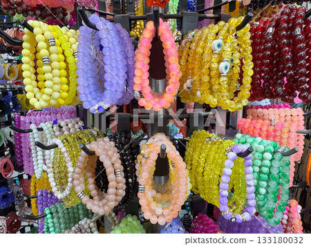 A bright display of multi-colored beaded bracelets in an accessories store A bright display of multi-colored beaded bracelets in an accessories store 133180032