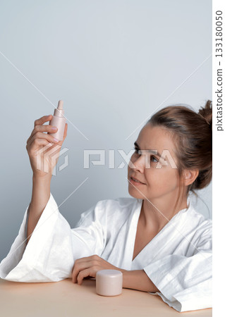 Woman using beauty serum for skincare routine Woman using beauty serum for skincare routine 133180050