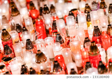 Glowing Memorial Candles in Red and White Creating a Peaceful Night Atmosphere 133180400