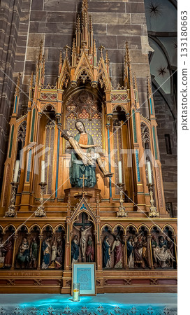 Intricate wooden altar featuring a statue of a mother holding her child, surrounded by detailed carvings and soft lighting, creating a serene atmosphere of reverence 133180663