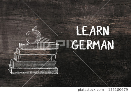 Stack of books with apple on top and text promoting learning German language skills 133180679