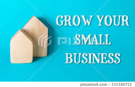 Wooden house shapes on vibrant blue background representing growth in small business concepts Wooden house shapes on vibrant blue background representing growth in small business concepts 133180722