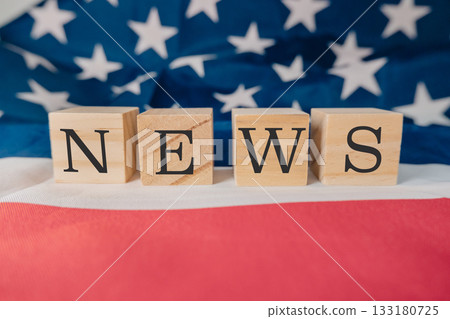 Wooden blocks spelling news on a background of an American flag with vibrant colors and textures Wooden blocks spelling news on a background of an American flag with vibrant colors and textures 133180725