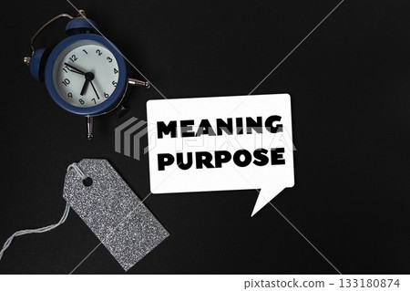 Blue alarm clock sits on a black background with the words Meaning Purpose Blue alarm clock sits on a black background with the words Meaning Purpose 133180874