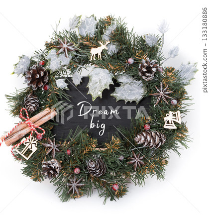 Festive holiday wreath adorned with pinecones, cinnamon sticks, and a motivational message 133180886