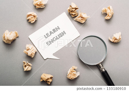 A white sign with the word learn written on it is surrounded by shredded paper A white sign with the word learn written on it is surrounded by shredded paper 133180910