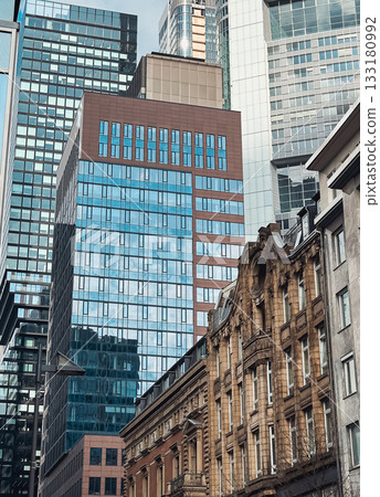 Modern skyscrapers and historic buildings juxtaposed in urban cityscape with reflective glass 133180992