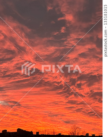 Vibrant sunset sky filled with dramatic clouds in shades of orange and pink, creating a stunning natural display of color and texture Vibrant sunset sky filled with dramatic clouds in shades of orange and pink, creating a stunning natural display of color and texture 133181015