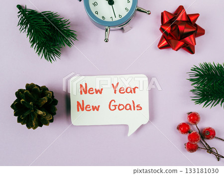 New Year celebration with clock, festive decorations, and motivational message on pastel background 133181030
