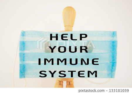 Mannequin is holding a blue face mask with the words Help Your Immune System 133181039